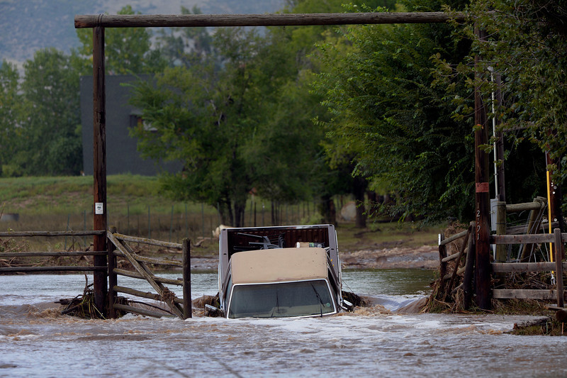 A truck rests flooded at the entrance to Ron Krenzel's property on 61st Street near Longmont, CO September 14, 2013. (Photo By Craig F. Walker / The Denver Post)
