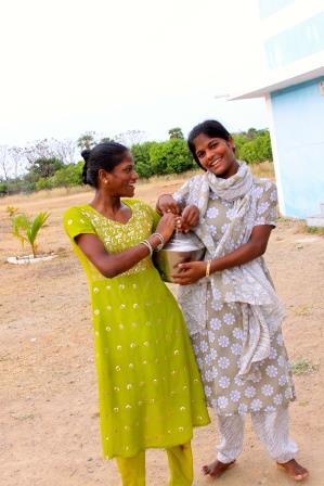 Sathya and Gayathri carrying water